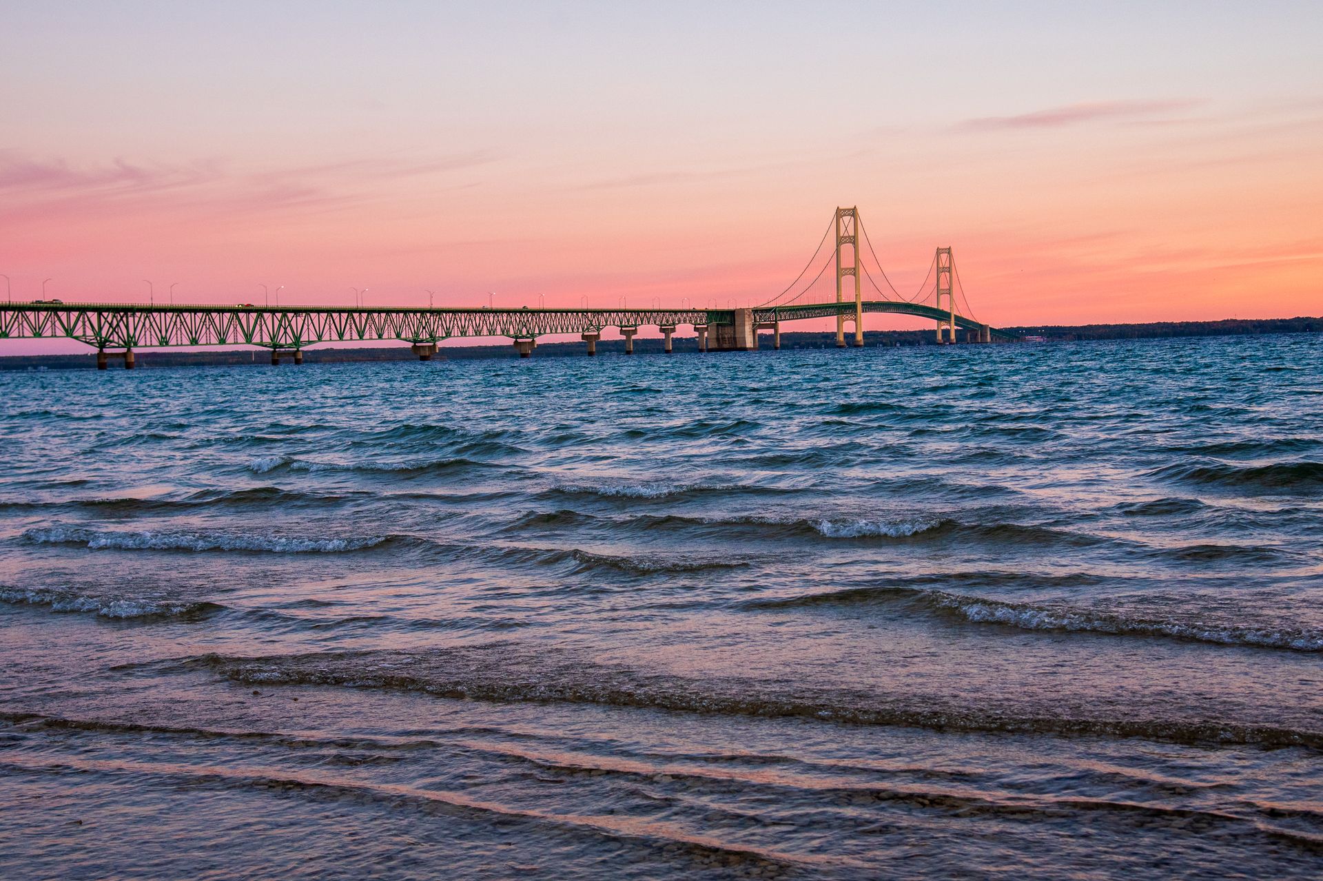 The Mackinac Bridge stretching across the water at sunset in Michigan